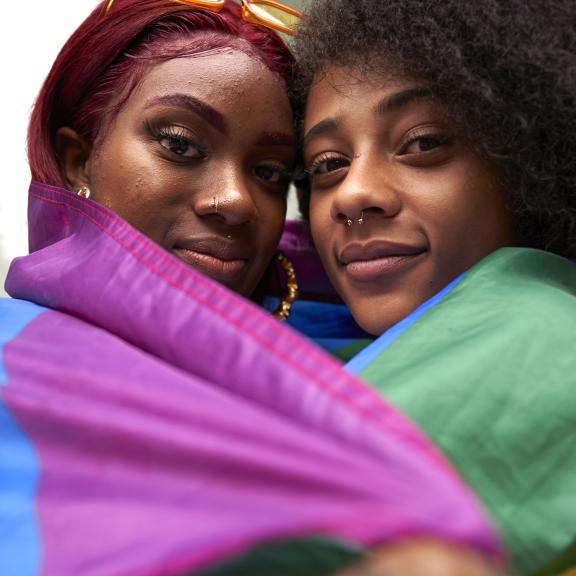 2 women with colourful flag